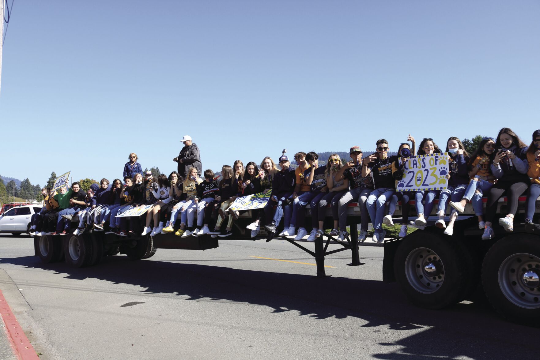 Brookings Harbor H.S. students hitch a ride aboard a Leatherneck Logging trailer bed.jpg
